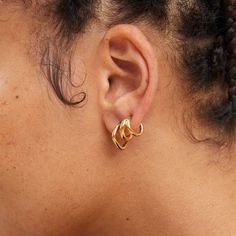 With soft organic lines, the Laini Mini Hoops were inspired by the concept of liquid geometry. Handcrafted by artisans in Kenya with 24k gold plated brass using traditional techniques. Handcrafted in gold plated brass by artisans in Kenya. Your purchase promotes artisan innovation + entrepreneurship. To learn more about keeping your jewelry shining like new, see our Product Care Guide. Height: 1.35cm Width: 1.4cm Innovation And Entrepreneurship, Tarnish Remover, Organic Lines, Mini Hoop Earrings, Selling Jewelry, Traditional Techniques, Cloth Bags, Kenya, Geometry