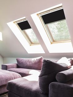 a living room with two skylights above the couch