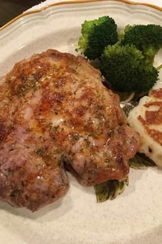 a white plate topped with meat and broccoli