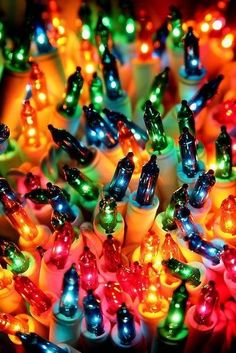 many colorful lights that are on top of each other