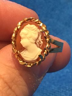 Beautiful vintage gold 10k cameo ring. Approximately created in the 1960s  this vintage beauty is sure to make a statement and become a conversation piece in any setting, great gift for any vintage lover or vintage treasure collector. Crafted in 10k gold it is stamped and hallmarked as so. This mid century ring  portrays the hand carved image of a young lady. The ring is approximately size 7.5 and can be sized by your local jeweller. The natural light shimmers off the buttery piece as if melting Antique Cameo Ring Collectible, Victorian Gold Cameo Rings, Gold Oval Cameo Rings, Vintage Gold Cameo Ring, Cameo 14k Gold Rings For Collectors, Vintage 14k Gold Cameo Rings, Collectible 14k Gold Cameo Rings, Gold Cameo Ring Jewelry, Gold Cameo Rings For Anniversary