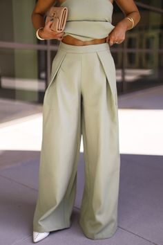 Introducing our So Iconic Pant, a must-have for NYC fashion lovers. Featuring stunning pleated details, high waisted design, and oversized silhouette, these pants exude chic and sophistication. With a relaxed fit and oversized style, they offer both comfort and elevated style, perfect for any occasion from bridal to workwear. Upgrade your wardrobe with these trendy and classy pants that combine comfort and style effortlessly. * So Iconic Top sold separately Self 100% Polyester Lining 100% Polyester Hand wash cold. Classy Pants, Elevated Style, Satin Pants, Oversized Style, Nyc Fashion, Oversized Silhouette, Dresses Xs, Fashion Lover, Casual Pants