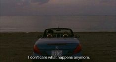 a car parked on the beach with an ocean in the background and a message written below it