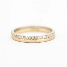 a yellow gold wedding band with white diamonds