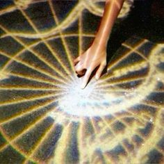 a person's hand touching the center of a circular object