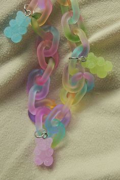 several different colored bracelets with flowers on them sitting on a bed sheet in the sun