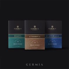 three boxes of coffee on a black background with the words germaa written in gold