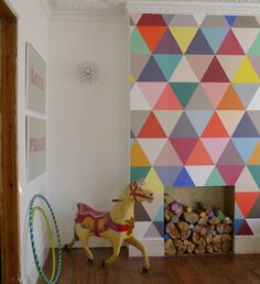 there are many colorful wallpapers in this room and one has a toy horse on the floor