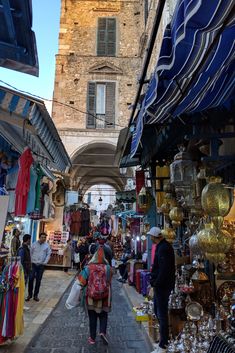 people are walking through an outdoor market area