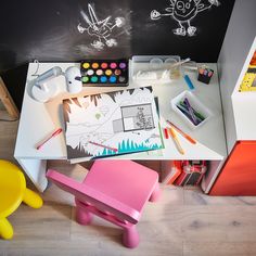 a child's desk with toys and art supplies