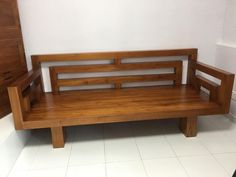 a wooden bench sitting on top of a white tiled floor