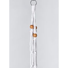 a white rope with wooden beads hanging from it