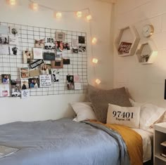 a bedroom with pictures on the wall and a laptop computer sitting on top of it