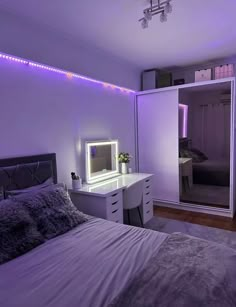 a bed room with a neatly made bed and purple lighting