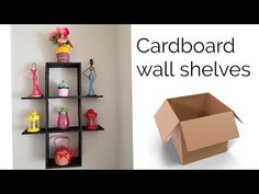 there is a cardboard box on the wall next to shelves with toys and vases