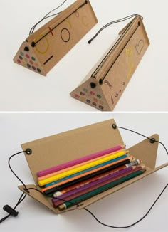 the cardboard box is filled with pencils and crayons