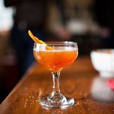 an orange slice is placed on the rim of a cocktail