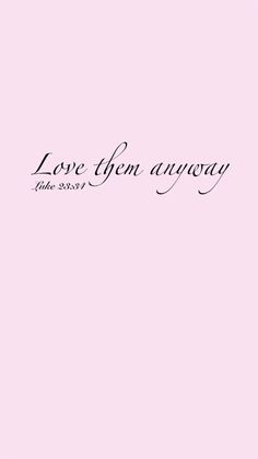 a pink wall with the words love them anyway written in cursive writing on it