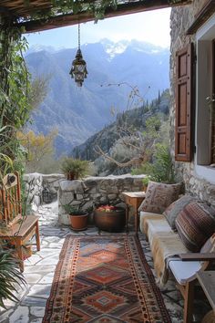 an outdoor area with a couch, chair and rug