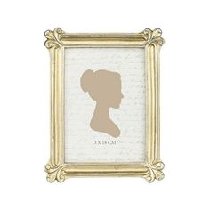 the silhouette of a woman's head in a gold frame