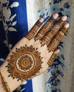 a woman's hand with henna on it