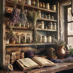 an open book sitting on top of a table next to vases and jars filled with flowers