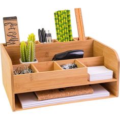 a wooden desk organizer with pens, pencils, and other office supplies in it