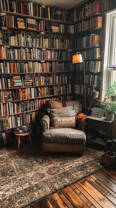 Cozy reading nook with armchair, throw pillows, and bookshelves, ideal for book enthusiasts. 70s Home Library, House Filled With Books, Book Shelf Library Design, Bookshelves Small Living Room, Reading Book Bedroom, Book Closet Ideas, Small Libraries In Houses, Book Bedroom Ideas