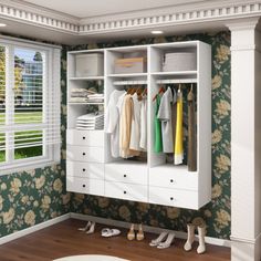 an open closet with clothes hanging on it