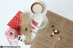 a mason jar filled with liquid sitting next to some twine and other crafting supplies