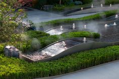 an outdoor water feature in the middle of a park