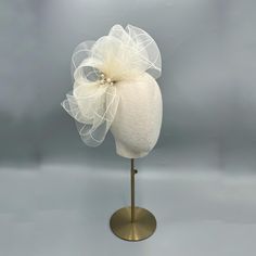 This ivory fascinator been created by hand using ivory crinoline with a diamond design running through the material.  Beautiful gold flowers have been added, along with ivory beads.  it would be suitable for most formal events - races, weddings, parties etc Crinoline is made from woven nylon thread, making it a great option for outdoor wear - you don't have to worry about getting it wet! Mounted on a headband.  This fascinator will be shipped in a standard box.  You can choose to add a luxury bo Ivory Fascinator, Outdoor Outfits, Mini Hats, Wedding Fascinators, Ivory Wedding, Luxury Boxes, Diamond Design, Outdoor Wear, Gold Flowers