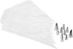 a white napkin with six silver cones on it and one is folded in the shape of a triangle