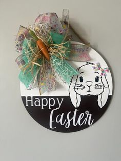 a sign that says happy easter with a bunny on it and a carrot in the center