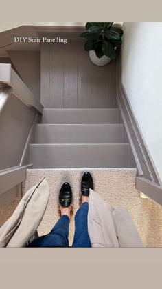 a person standing in front of stairs with their feet on the ground next to them