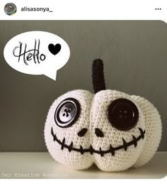 a crocheted jack - o - lantern with a speech bubble above it