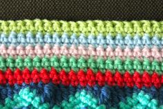 the crochet is multicolored and ready to be used as a blanket