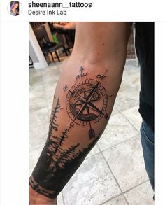 a man with a compass tattoo on his arm