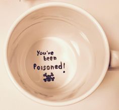 a white cup with writing on it that says you've been poisoned