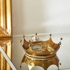 a gold crown sitting on top of a glass table