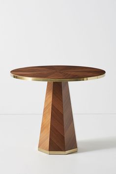 a wooden table sitting on top of a white floor