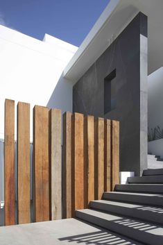 an outdoor stair case with wooden slats on the side and concrete steps leading up to it