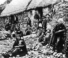 an old black and white photo of people in front of a hut