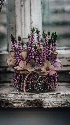 some purple flowers are sitting on a table