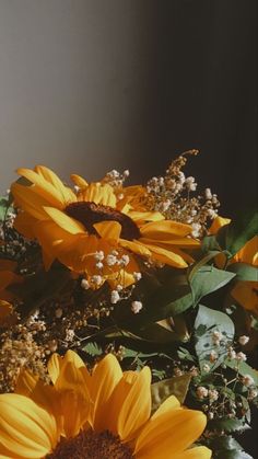 yellow sunflowers and other flowers in a vase