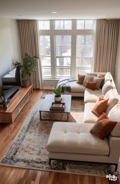 a living room filled with furniture and a flat screen tv on top of a wooden floor