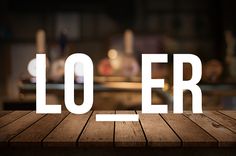 a wooden table with the word lo er spelled in white on it's surface