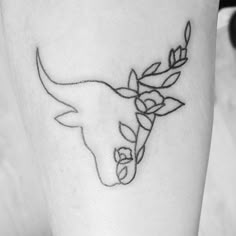 a black and white photo of a woman's thigh with flowers on it