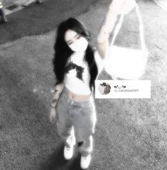 a girl with long black hair is standing on the carpet and holding a white bag