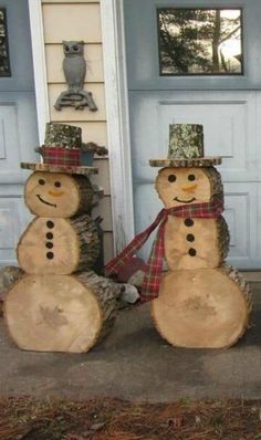 two snowmen are standing next to each other in front of the door and one is wearing a hat